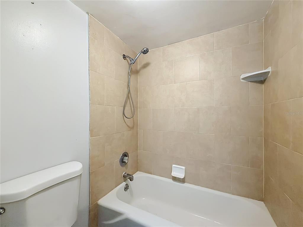 2636 Lemon Tree Lane, Unit 2636 Orlando, FL 32839 - Photo 35 of 51 a bathroom with a sink a toilet and shower