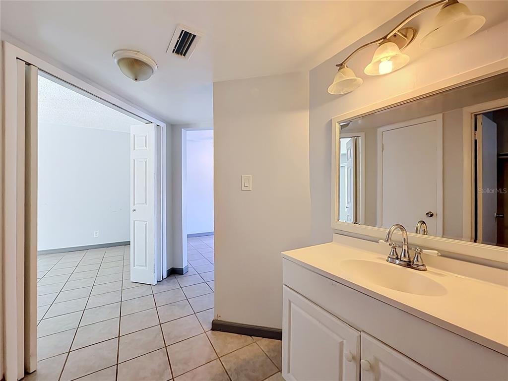 2636 Lemon Tree Lane, Unit 2636 Orlando, FL 32839 - Photo 37 of 51 a bathroom with a sink and a mirror