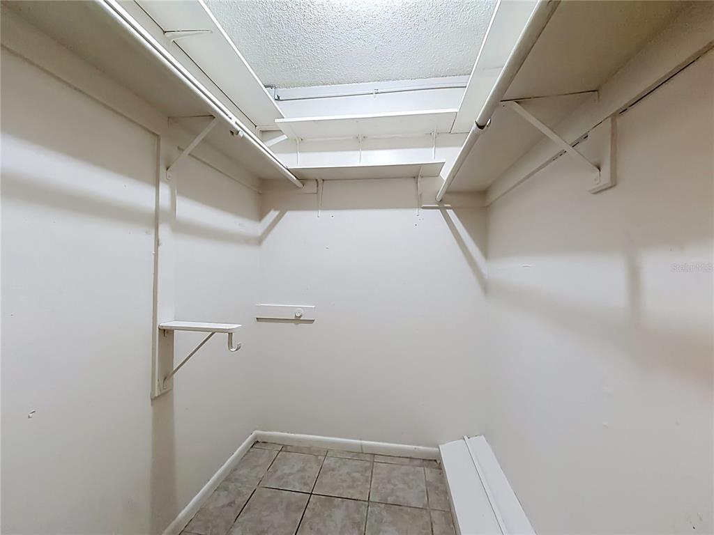 2636 Lemon Tree Lane, Unit 2636 Orlando, FL 32839 - Photo 38 of 51 a view of walk in closet with empty racks