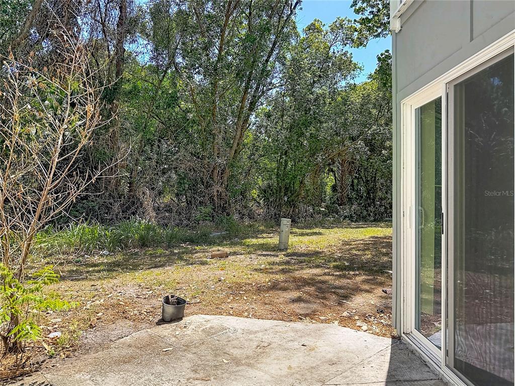 2636 Lemon Tree Lane, Unit 2636 Orlando, FL 32839 - Photo 39 of 51 a view of a backyard with large trees