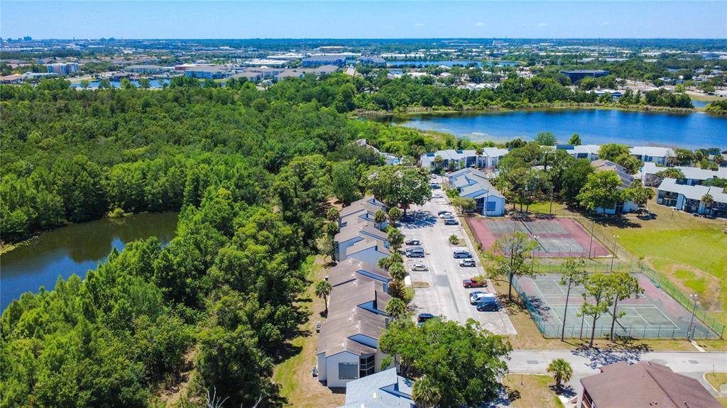 2636 Lemon Tree Lane, Unit 2636 Orlando, FL 32839 - Photo 46 of 51 an aerial view of lake and residential houses with outdoor space