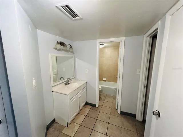 a bathroom with a sink mirror toilet and bathtub