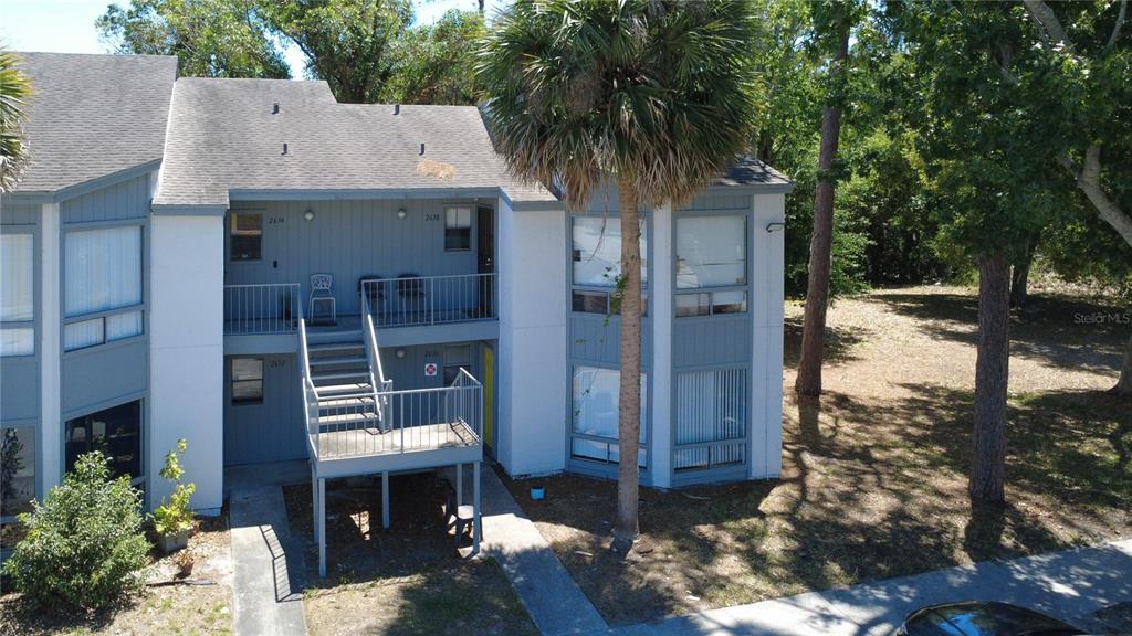 2636 Lemon Tree Lane, Unit 2636 Orlando, FL 32839 - Photo 6 of 51 a front view of a house with a yard
