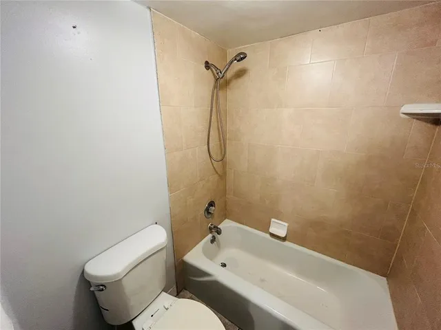 a bathroom with a toilet sink and shower