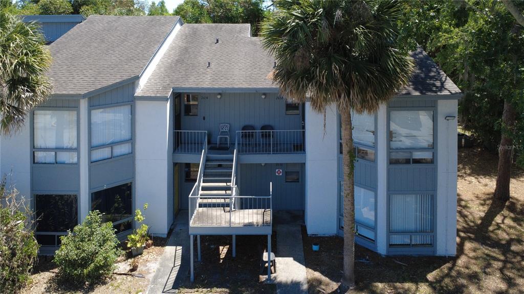 2636 Lemon Tree Lane, Unit 2636 Orlando, FL 32839 - Photo 8 of 51 a front view of a house with a garden