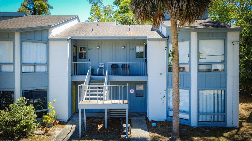 2636 Lemon Tree Lane, Unit 2636 Orlando, FL 32839 - Photo 10 of 51 a front view of a house with a garden