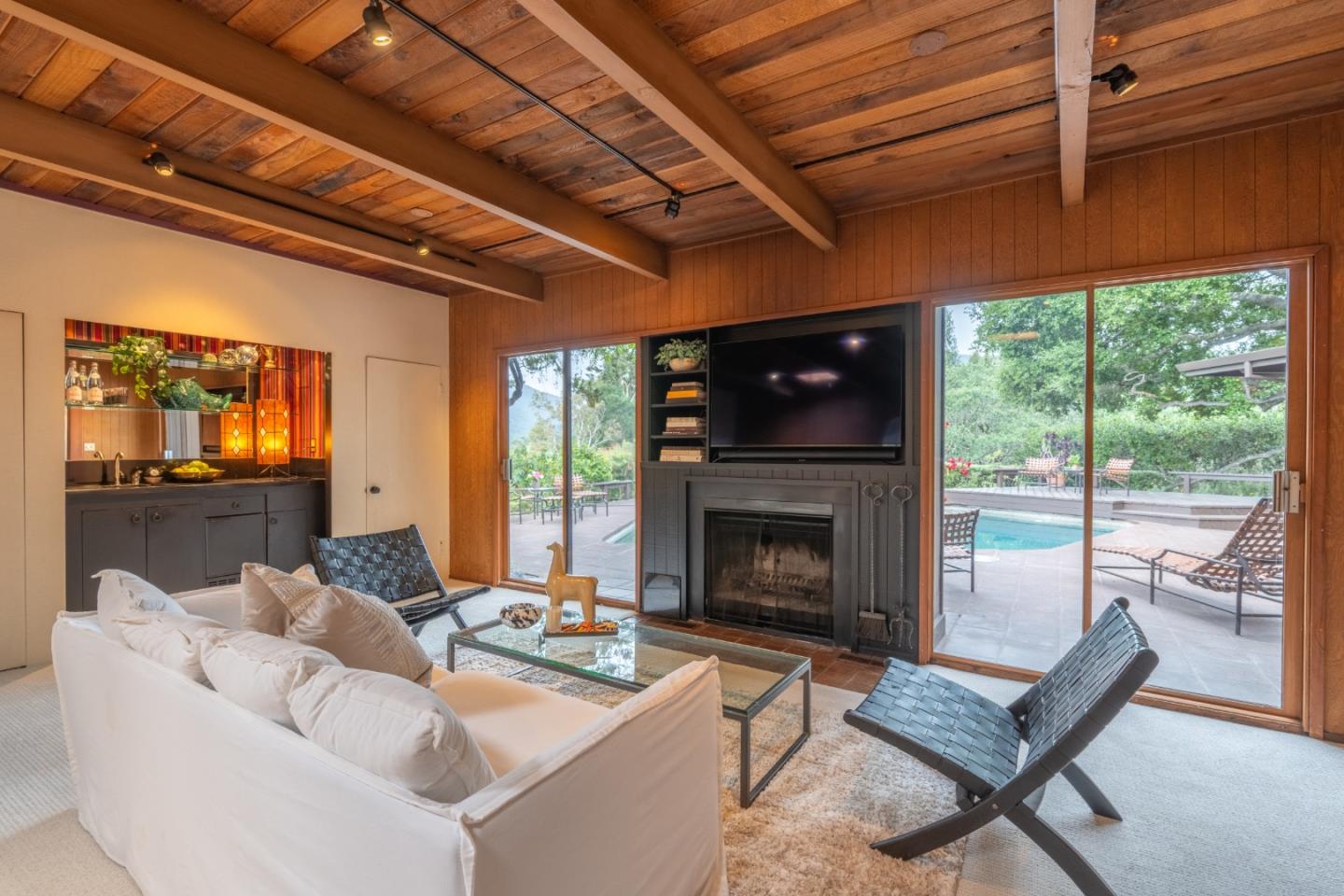46 Middle Canyon Road Carmel Valley, CA 93924 - Photo 6 of 74 a living room with furniture a fireplace and a table