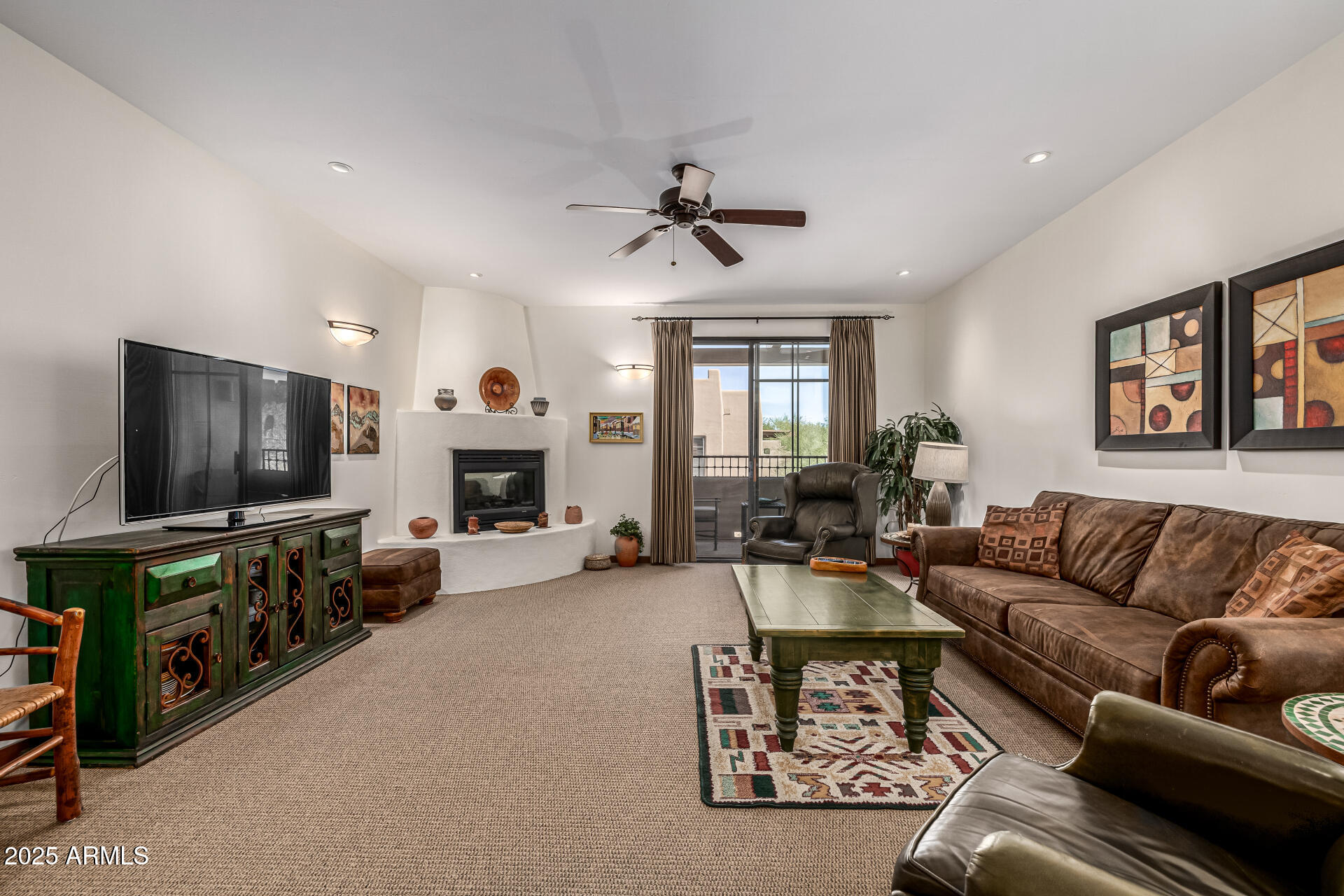 36601 North Mule Train Road, Unit C33 Carefree, AZ 85377 - Photo 11 of 61 a living room with furniture and a flat screen tv