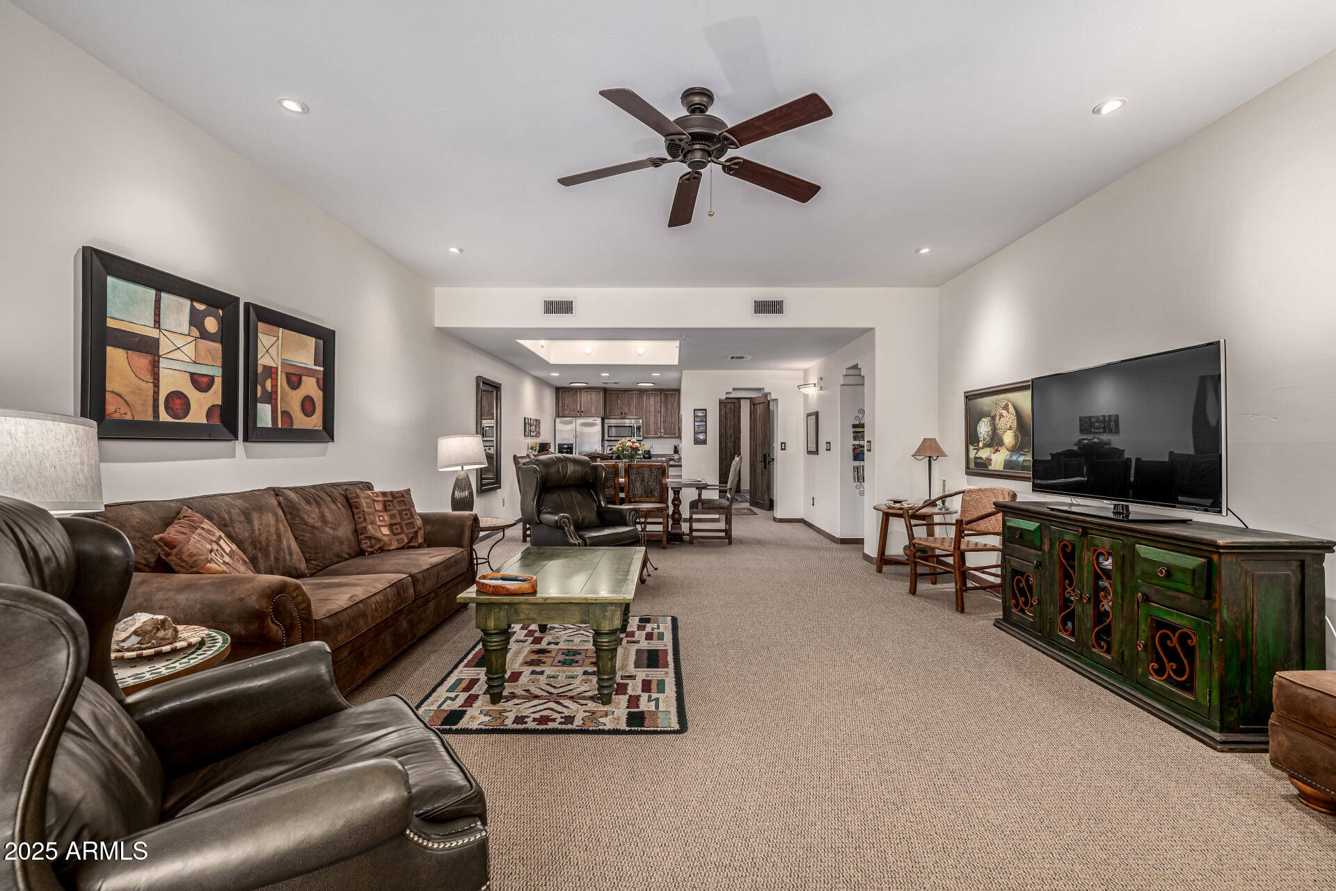 36601 North Mule Train Road, Unit C33 Carefree, AZ 85377 - Photo 13 of 61 a living room with furniture and a flat screen tv