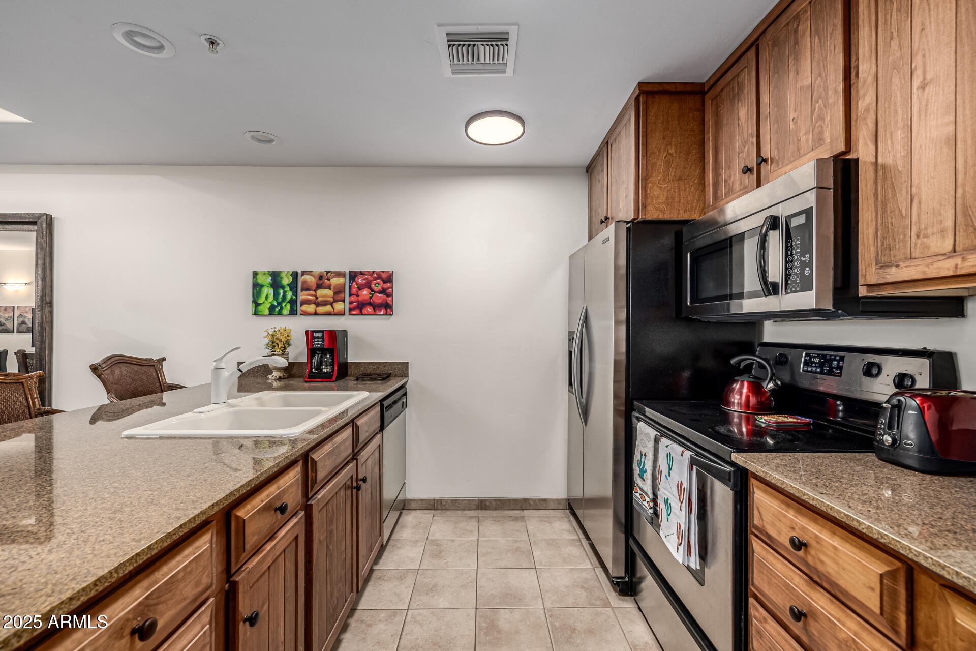 36601 North Mule Train Road, Unit C33 Carefree, AZ 85377 - Photo 14 of 61 a kitchen with stainless steel appliances granite countertop a sink stove and cabinets