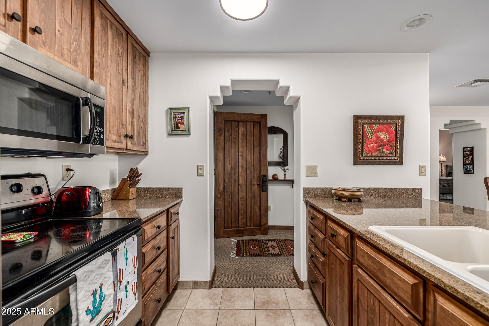 36601 North Mule Train Road, Unit C33 Carefree, AZ 85377 - Photo 16 of 61 a kitchen with stainless steel appliances granite countertop a sink stove and refrigerator