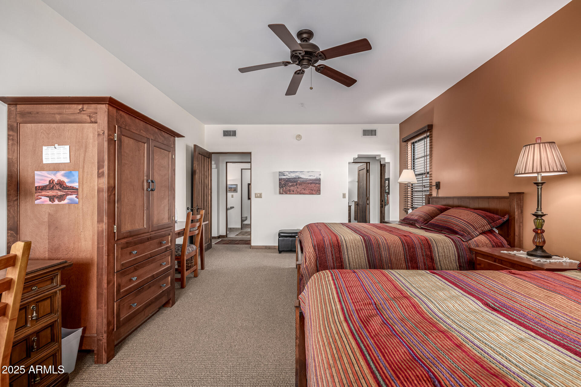 36601 North Mule Train Road, Unit C33 Carefree, AZ 85377 - Photo 20 of 61 a bedroom with a bed and a chandelier