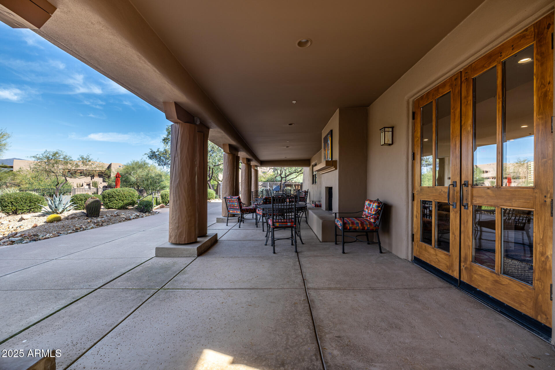 36601 North Mule Train Road, Unit C33 Carefree, AZ 85377 - Photo 46 of 61 a view of a porch with chairs and floor to ceiling window