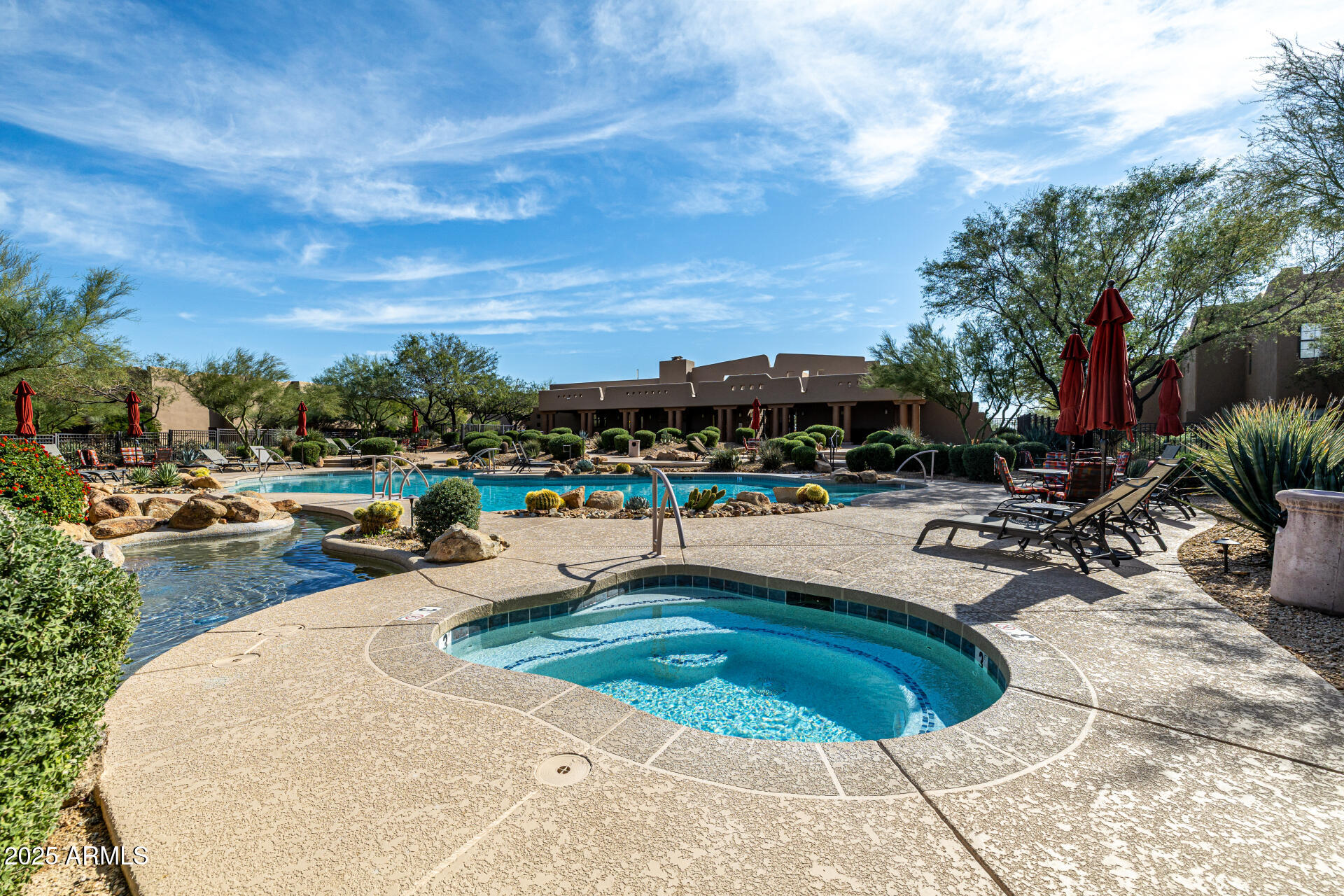 36601 North Mule Train Road, Unit C33 Carefree, AZ 85377 - Photo 49 of 61 a view of a swimming pool with lawn chairs and plants