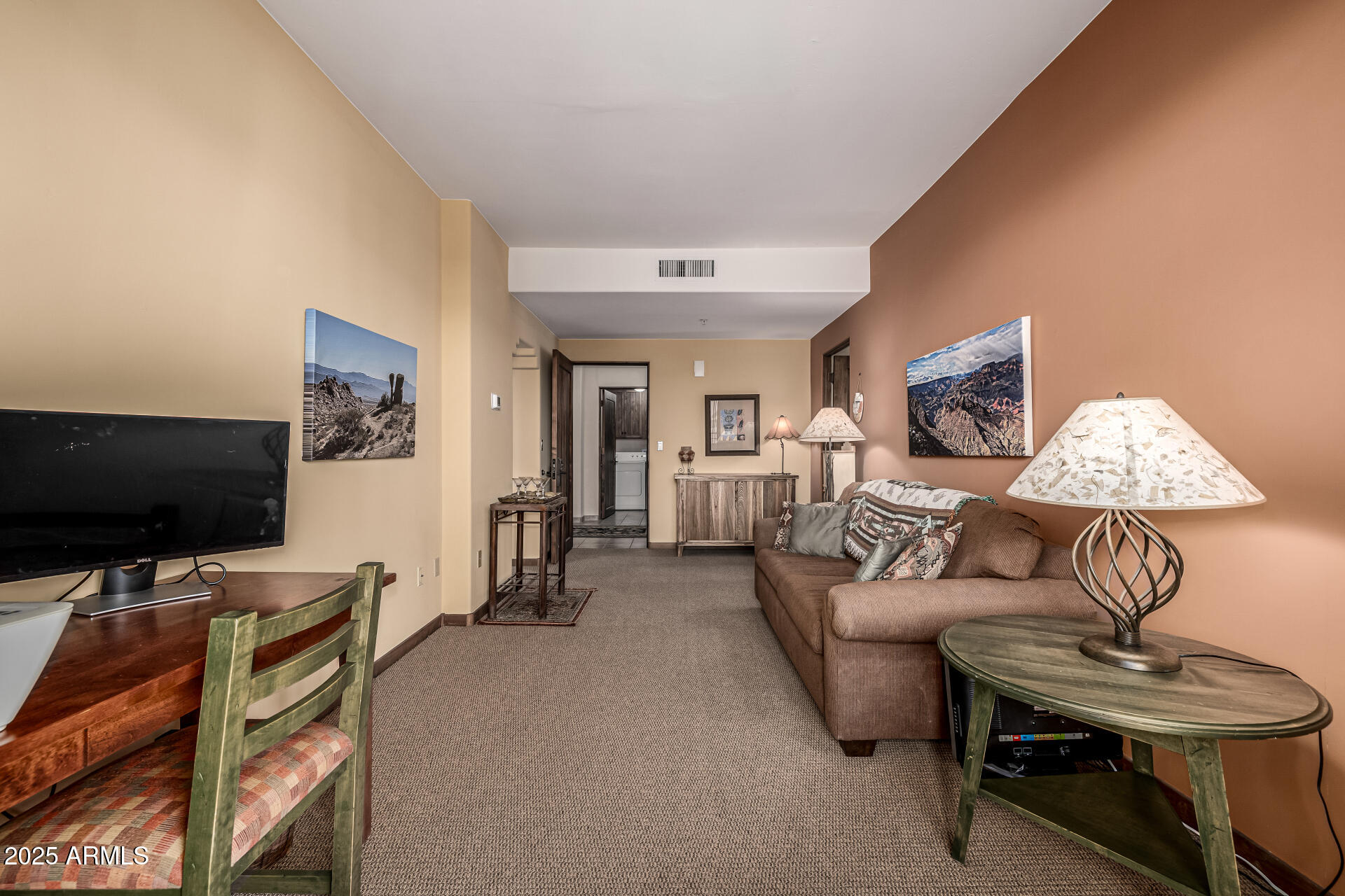 36601 North Mule Train Road, Unit C33 Carefree, AZ 85377 - Photo 10 of 61 a living room with furniture and a flat screen tv