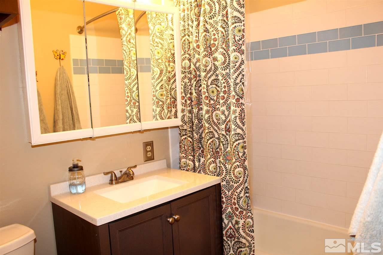1421 Samuel Way Reno, NV 89509 - Photo 16 of 25 a bathroom with a sink and a mirror