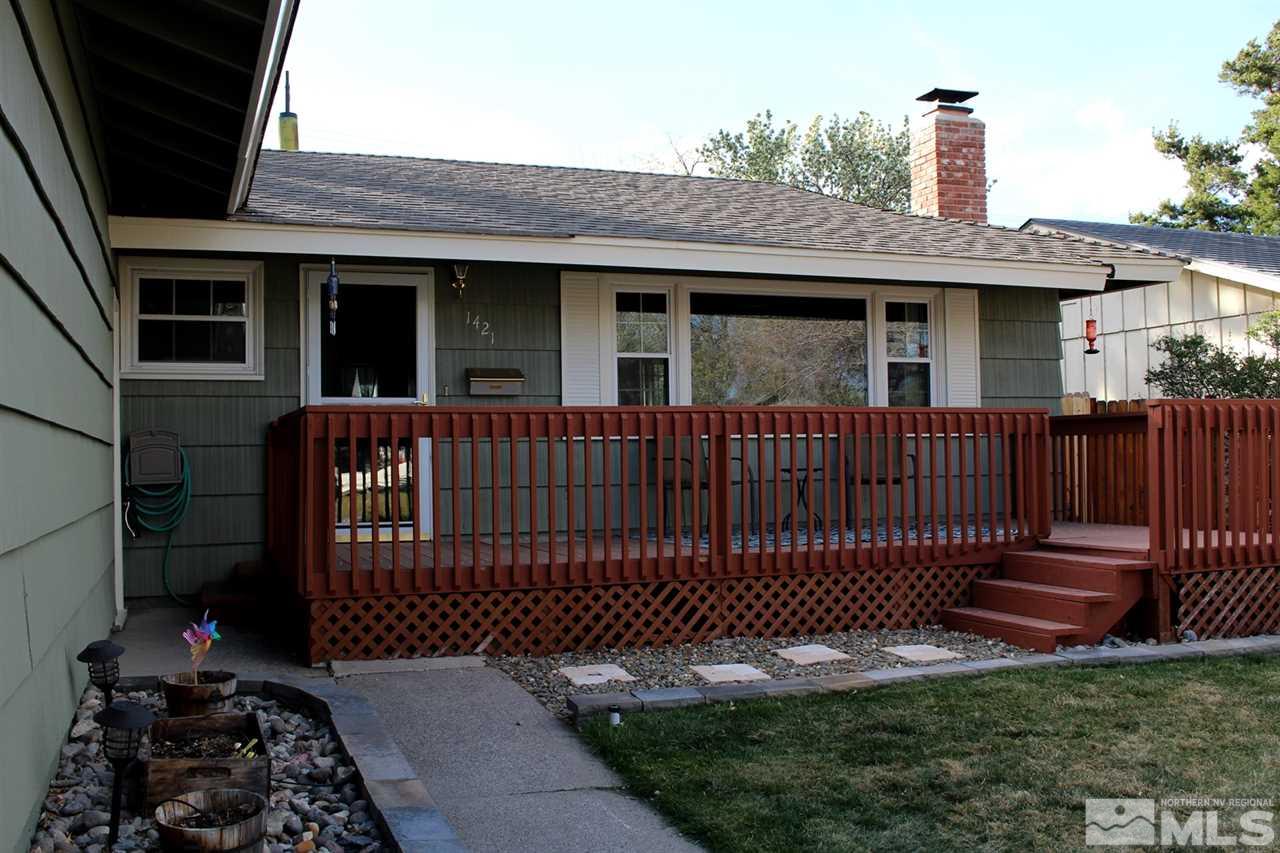 1421 Samuel Way Reno, NV 89509 - Photo 2 of 25 a front view of a house with a garden