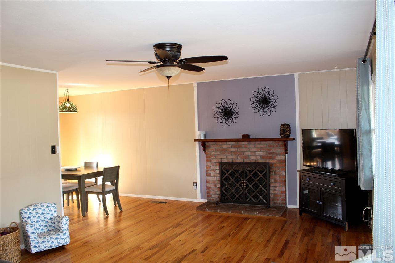 1421 Samuel Way Reno, NV 89509 - Photo 9 of 25 a living room with furniture and a fireplace