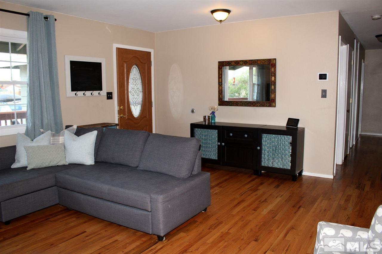 1421 Samuel Way Reno, NV 89509 - Photo 10 of 25 a living room with couches and a flat screen tv with kitchen view