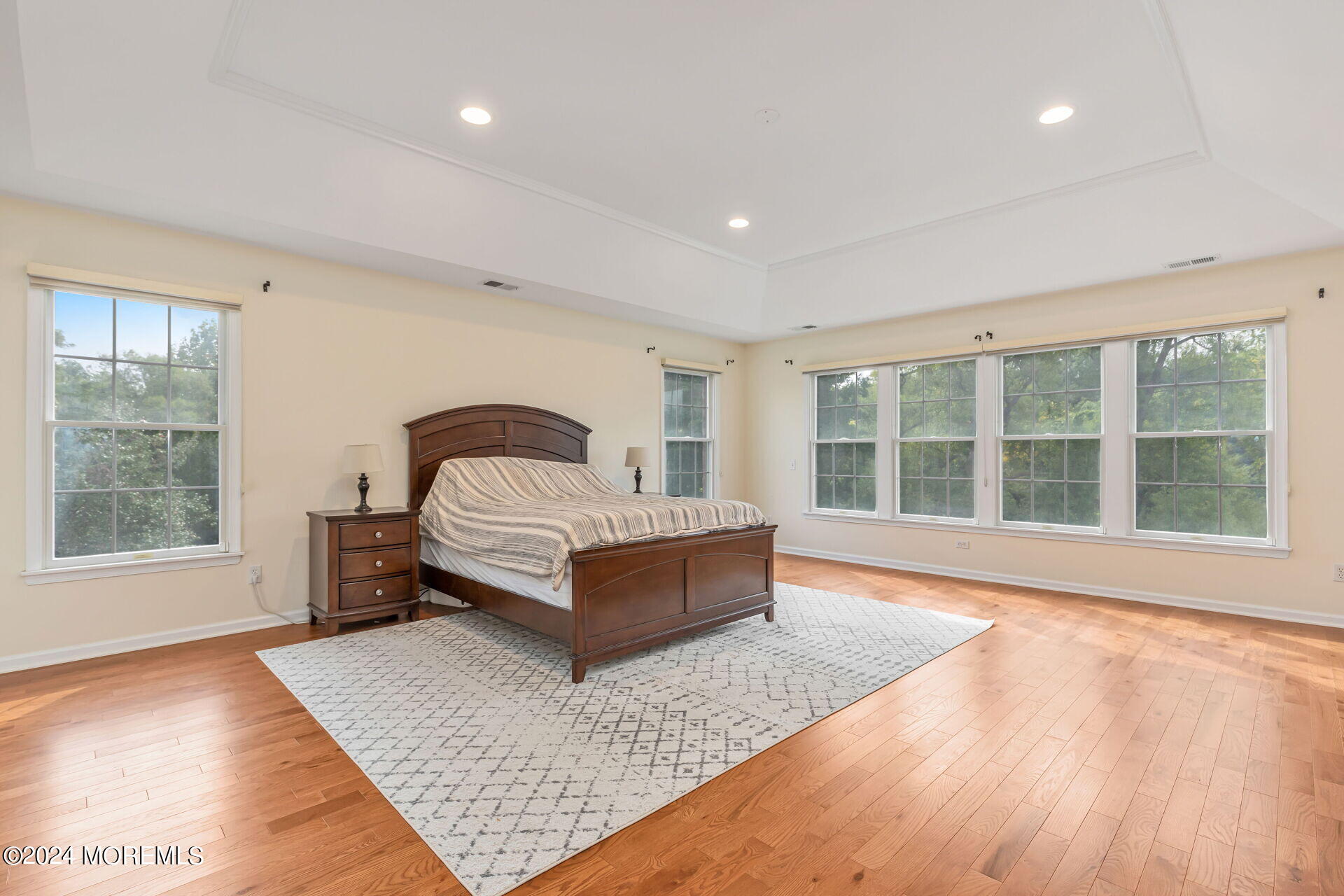 20 Crape Myrtle Drive Holmdel, NJ 07733 - Photo 23 of 53 a spacious bedroom with a bed and wooden floor