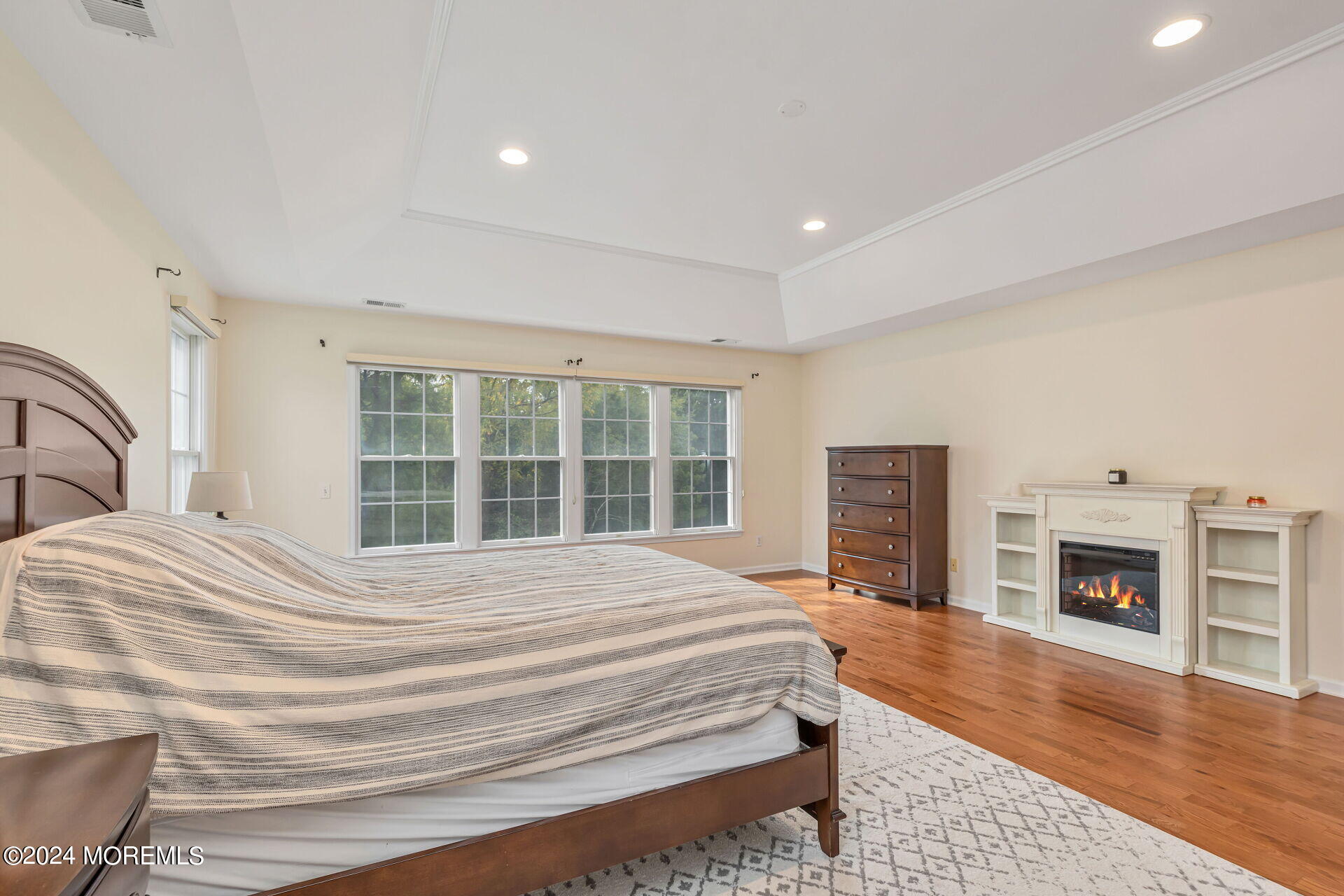 20 Crape Myrtle Drive Holmdel, NJ 07733 - Photo 24 of 53 a spacious bedroom with a large bed and a fireplace