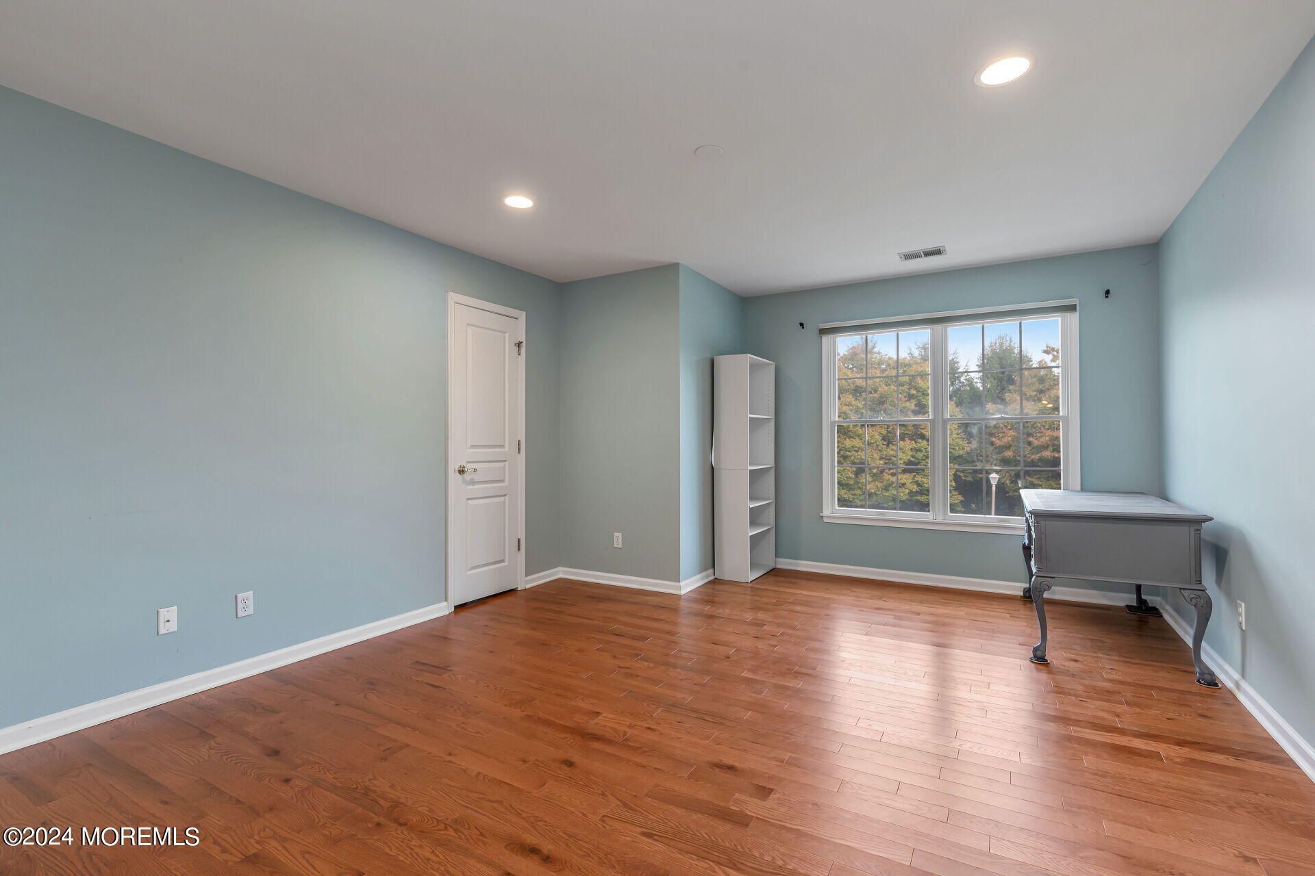 20 Crape Myrtle Drive Holmdel, NJ 07733 - Photo 28 of 53 a view of a big room with wooden floor and windows
