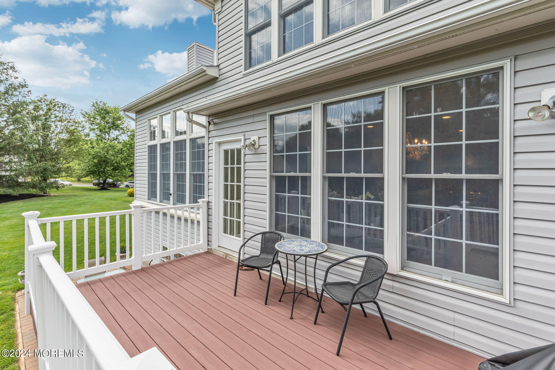 20 Crape Myrtle Drive Holmdel, NJ 07733 - Photo 37 of 53 a view of a deck with table and chairs with wooden floor and fence