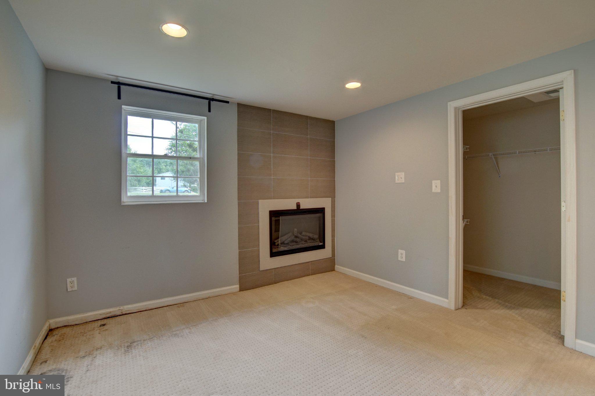 900 Walker Road Great Falls, VA 22066 - Photo 34 of 52 Cozy room with modern fireplace charm.