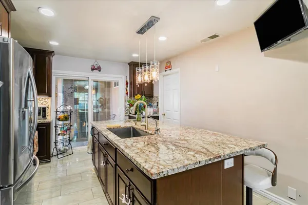 a kitchen with counter top space and stainless steel appliances
