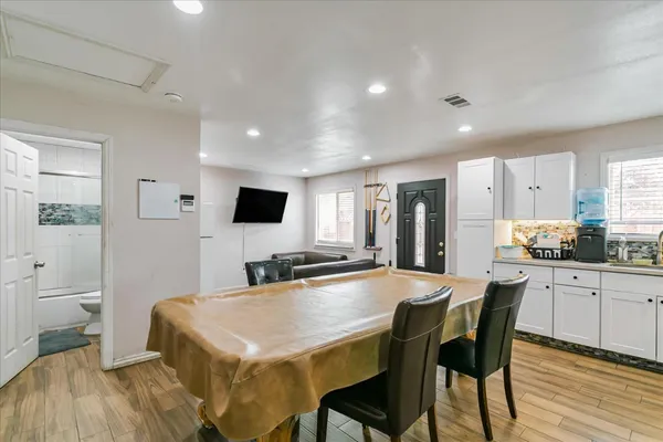 a large kitchen with kitchen island a dining table and chairs
