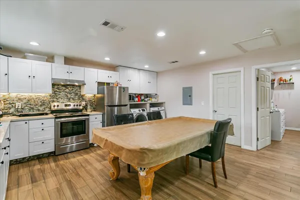 a kitchen with a table and chairs in it