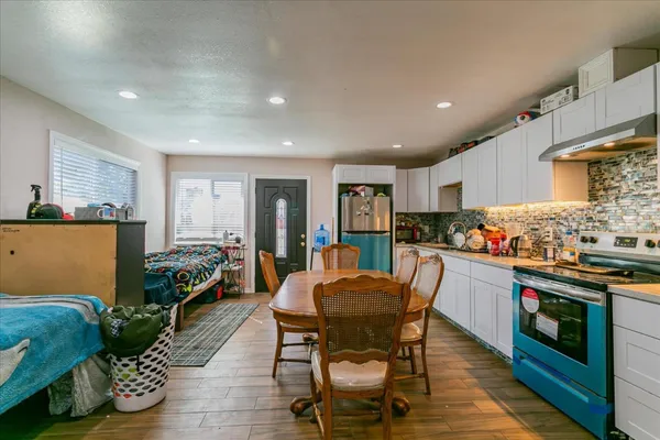 a kitchen with stainless steel appliances granite countertop sink stove top oven and cabinets