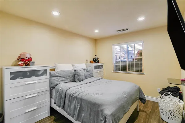 a bedroom with a bed and a window