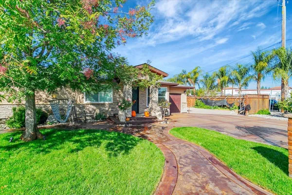 a view of a patio with table and chairs and potted plants