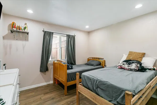 a bedroom with two beds and a window