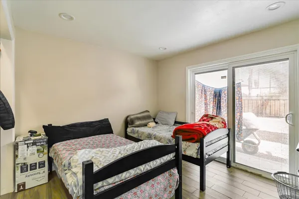 a bedroom with a bed and wooden floor