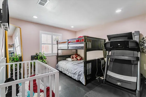 a bedroom with furniture and a window