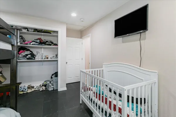 a bedroom with furniture and a flat screen tv