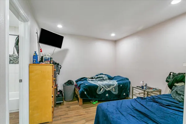 a bedroom with furniture and a flat screen tv