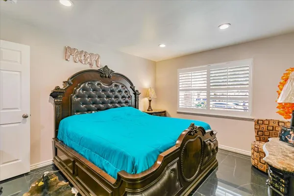 a bed sitting in a bedroom next to a window