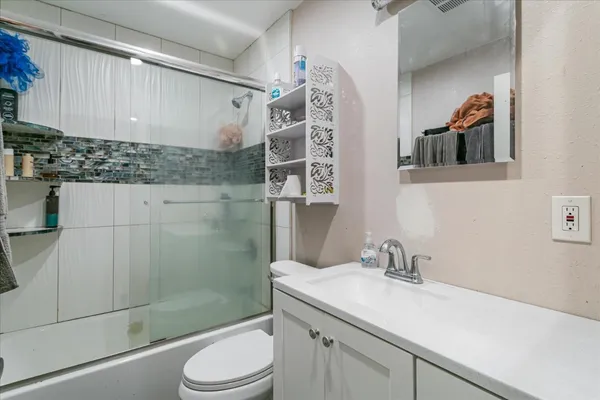 a bathroom with a sink toilet and shower