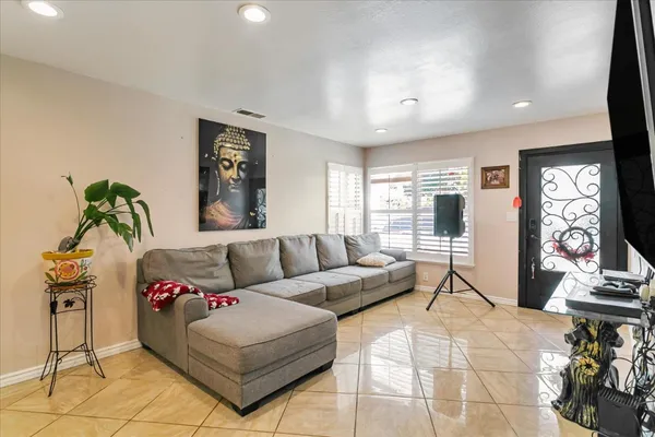 a living room with furniture and a flat screen tv