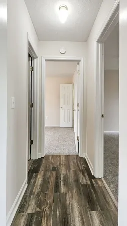 an empty room with closet and a chandelier fan