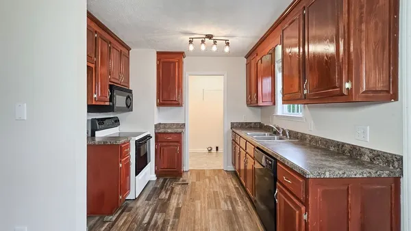 a kitchen with stainless steel appliances granite countertop a stove and a refrigerator