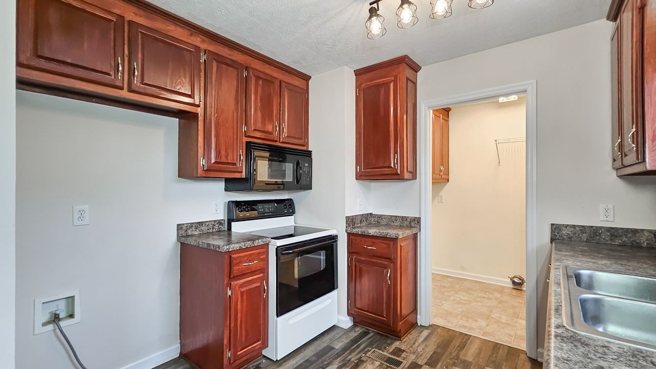 11 Amberwood Road Fayetteville, TN 37334 - Photo 8 of 36 a kitchen with stainless steel appliances granite countertop a stove a sink and a microwave