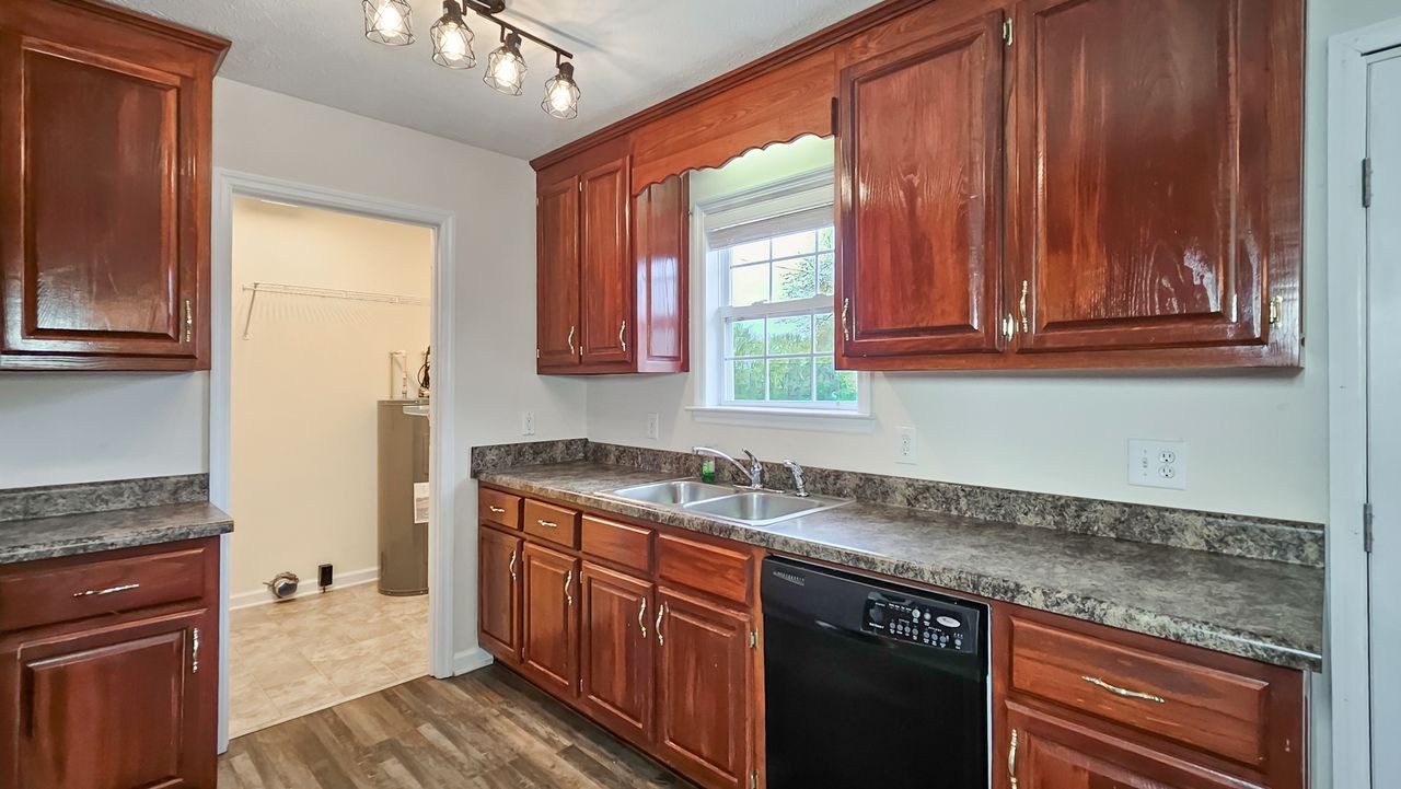 11 Amberwood Road Fayetteville, TN 37334 - Photo 9 of 36 a kitchen with granite countertop cabinets sink and window