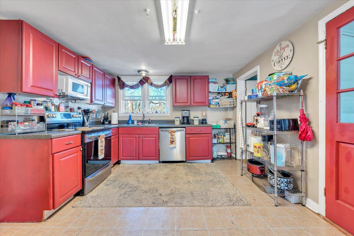 1319 Liberty Road Northeast Roanoke, VA 24012 - Photo 11 of 36 a kitchen with stainless steel appliances a stove top oven and a refrigerator