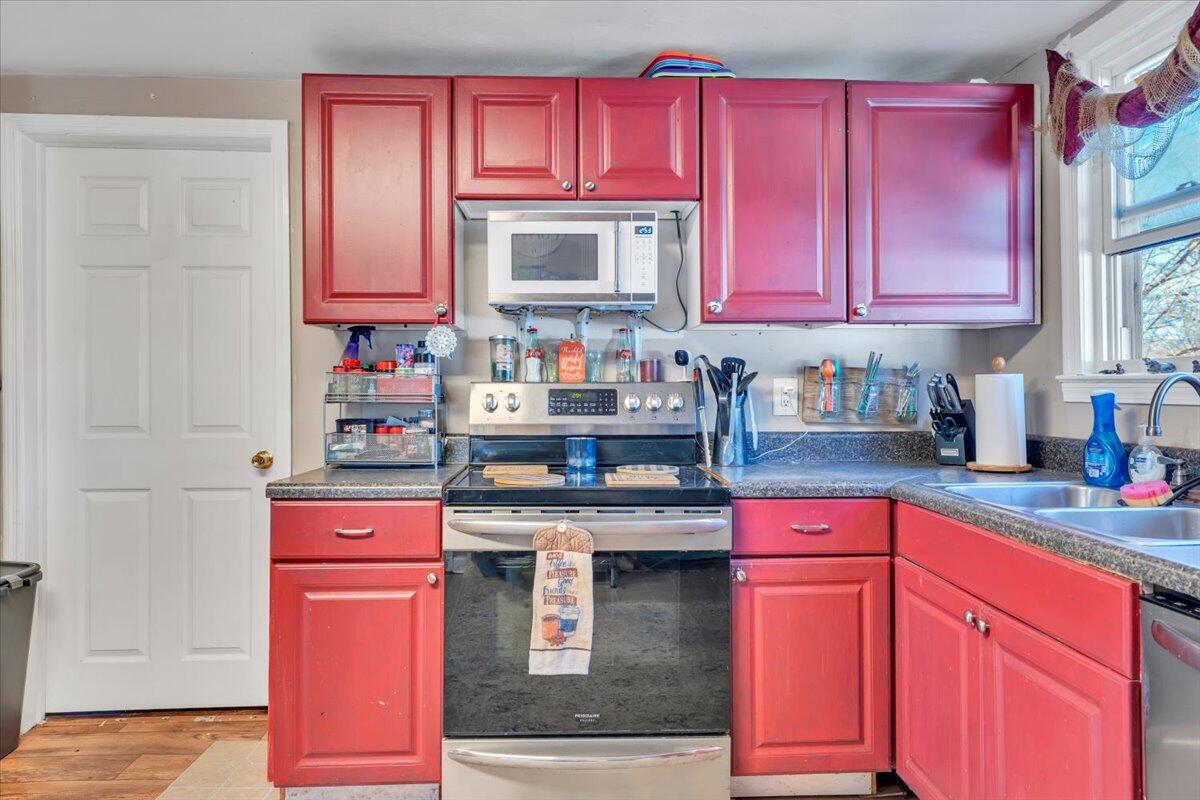 1319 Liberty Road Northeast Roanoke, VA 24012 - Photo 13 of 36 a kitchen with stainless steel appliances granite countertop a stove top oven