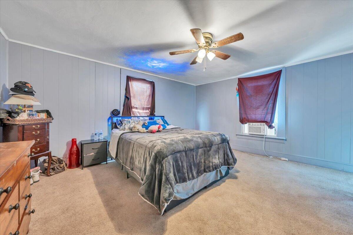 1319 Liberty Road Northeast Roanoke, VA 24012 - Photo 18 of 36 a spacious bedroom with a bed and a chandelier