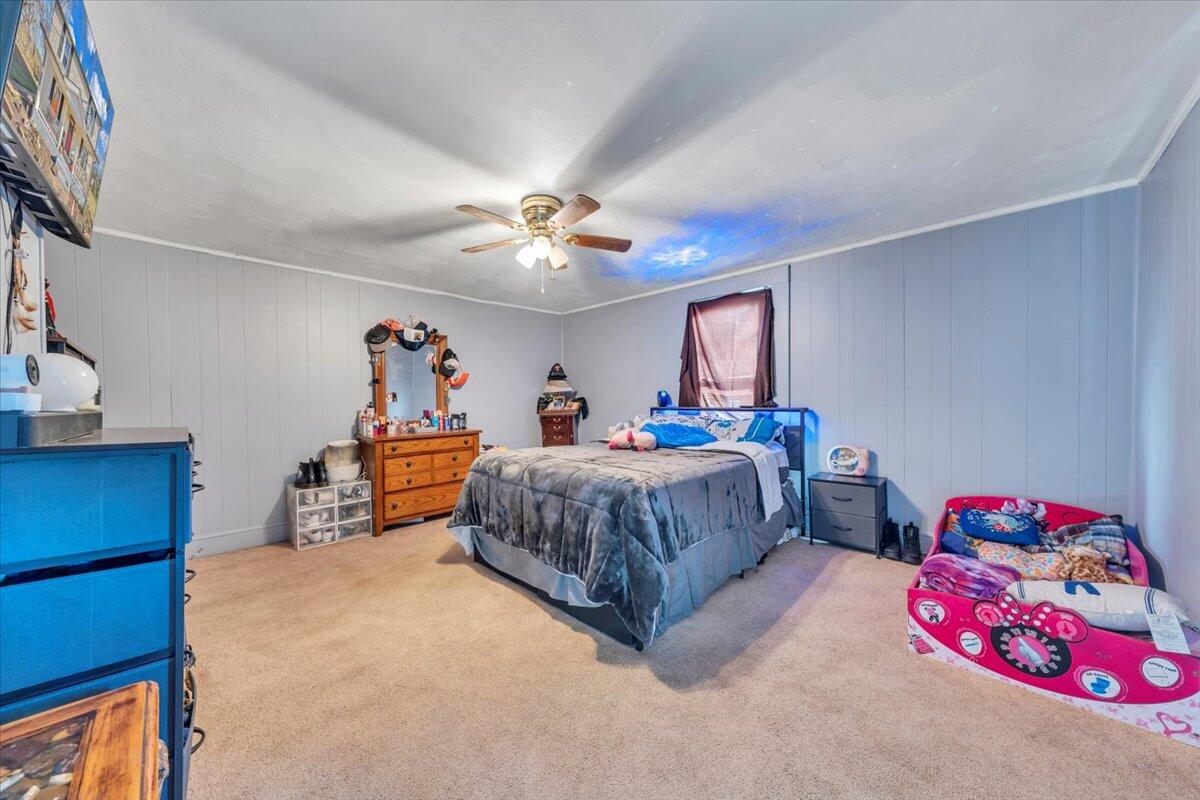 1319 Liberty Road Northeast Roanoke, VA 24012 - Photo 19 of 36 a bedroom with a bed and a chandelier
